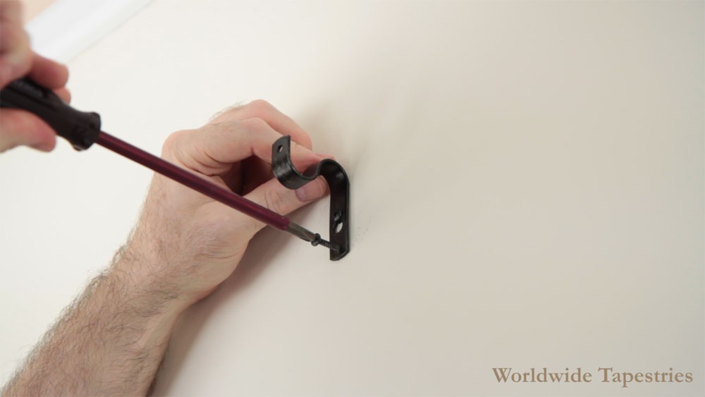 Install the wall plugs and screws for lower screw holes of brackets, and install the brackets
